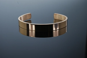 Close-up of minimalist rose gold stainless steel C-shaped open cuff bracelet