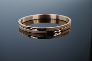 Detail view of 8mm rose gold stainless steel bangle with polished and matte textures