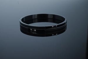 Close-up of black 8mm stainless steel hinge bracelet with polished finish and center groove