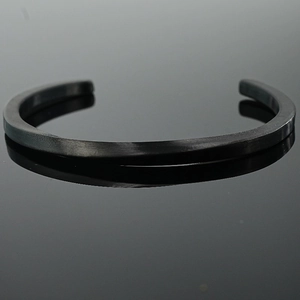 Minimalist matte black Mobius cuff bracelet in durable titanium steel with reflections