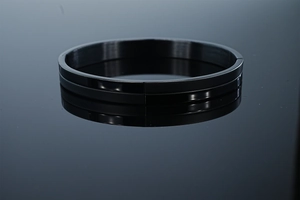 Detailed macro view of 8mm black frosted stainless steel bracelet with polished edges