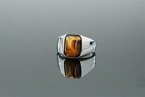 Macro detail of men's titanium steel ring featuring a rectangular tiger eye stone