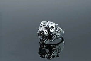 Macro shot of silver stainless steel tiger ring with detailed 3D roaring head relief