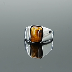 Men's titanium steel ring with rectangular tiger eye stone on a reflective background