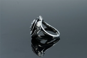Macro detail of vintage rose ring featuring multi-layered silver petals and hollow band