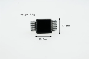 Macro detail of men's stainless steel square ring with black agate and 7.5g weight