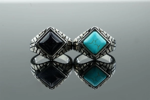 Macro detail of retro stainless steel rings with square blue stone and turquoise inlay