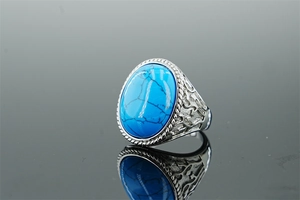 Macro detail of vintage turquoise ring with engraved silver patterns and blue stone