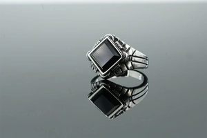Detailed view of men's vintage stainless steel ring featuring a square black agate stone