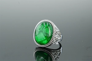 Detailed macro view of vintage stainless steel ring with green oval turquoise stone