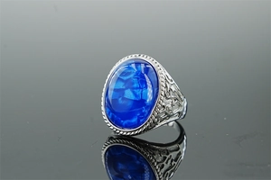 Macro detail of vintage stainless steel ring with oval blue turquoise stone and engravings