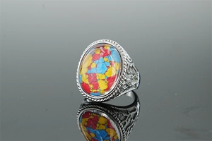 Detail view of vintage stainless steel ring with colorful mosaic stone and engraved floral band