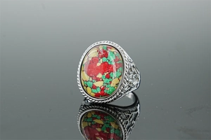 Detail of vintage silver ring featuring a large oval multi-color synthetic turquoise stone