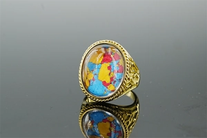 Detailed macro of gold vintage ring with mosaic colorful stone and engraved hollow pattern