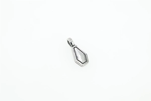 Détail macro du pendentif géométrique argenté avec incrustation en nacre et métal poli
