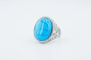 Macro shot of vintage stainless steel ring featuring large oval turquoise gemstone detail