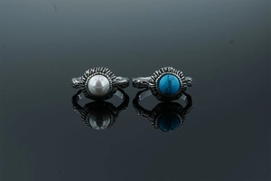Detailed macro view of vintage boho rings with white pearl and blue turquoise stones