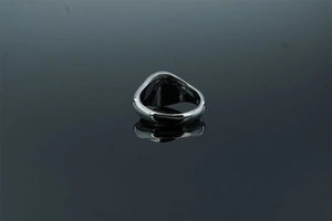 Detailed view of wide polished silver stainless steel ring with mirror finish reflections