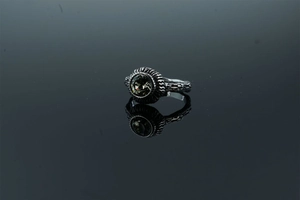 Detailed view of vintage silver ring featuring dark gemstone and lava texture finish