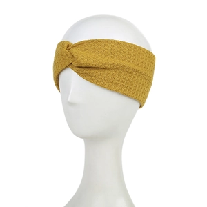 Classic mustard yellow knitted headband with cross-knot design on model head