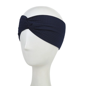 Detail of navy blue waffle knit headband with twisted design on white display