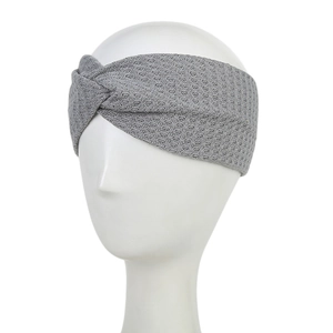 Detail of grey knitted twist headband showing waffle texture on a white model head