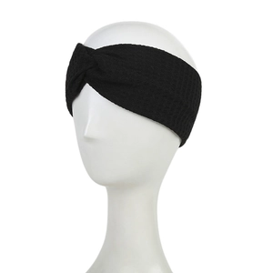 Close-up of black waffle fabric headband featuring a classic twist knot design