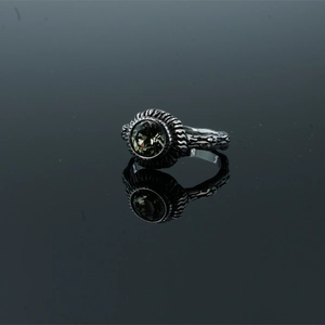 Vintage silver ring with a faceted dark grey gemstone and intricate engraved pattern