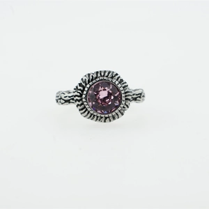 Vintage silver ring with engraved texture and a round purple gemstone centerpiece