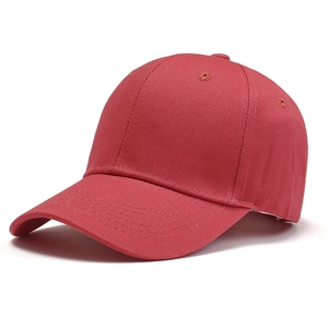 Side view of a classic red cotton twill baseball cap with structured six-panel design