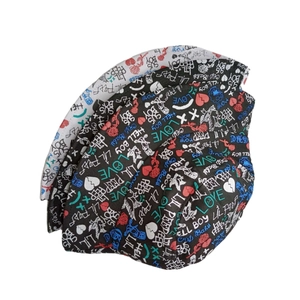 Detail of Lil Peep graffiti prints with hearts and roses on black and white bucket hats