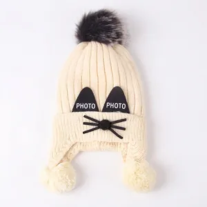Winter cartoon cat knit hat for children with earflaps and large grey pom-poms