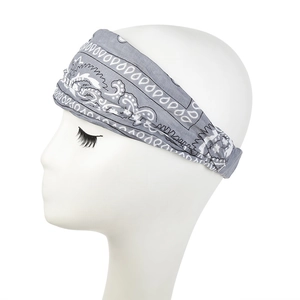 Detail of grey paisley print on wide elastic sports headband worn on a mannequin