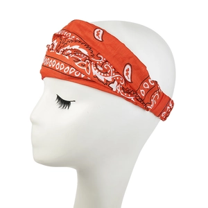 Close-up of orange paisley print elastic headband on a white mannequin head display