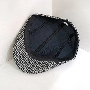 Detail of herringbone flat cap interior with black lining and size 58 label