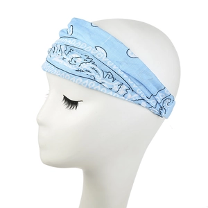 Close-up of light blue paisley print headband on model showing wide pleated fabric detail