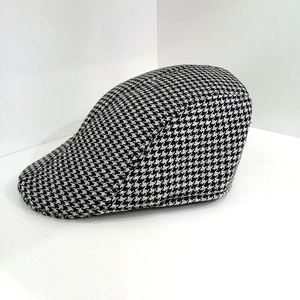 Close-up of the black and white houndstooth fabric texture on this classic wool beret hat