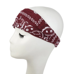 Detail of burgundy paisley print wide elastic headband on a white model head