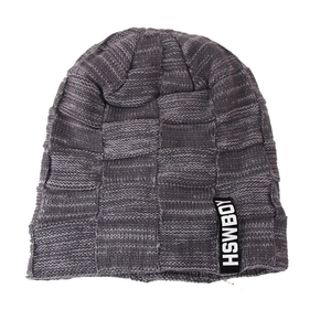 Detail of grey checkerboard knit beanie with thick yarn texture and branded side label