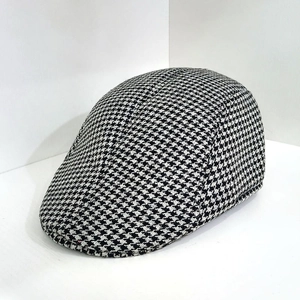 Detailed view of British style herringbone pattern and wool texture on the flat cap