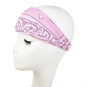 Detailed view of pink paisley pattern headband on model showing soft elastic fabric texture