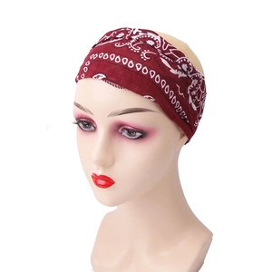 Detail view of burgundy paisley elastic headband shown on a female mannequin head