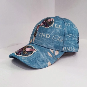 Close-up of vintage washed denim baseball cap featuring embroidered Beach surf patch