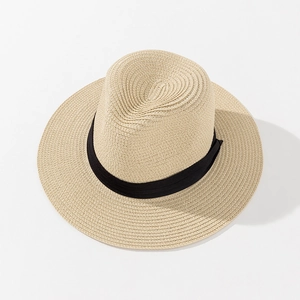 Detail of light beige straw Panama hat featuring a classic black decorative ribbon band