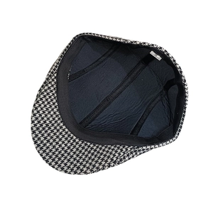 Internal view of wool blend herringbone beret hat with black lining and seam details