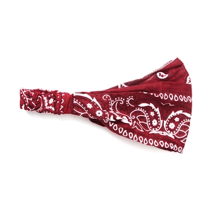 Close-up of burgundy paisley stretchy headband showing fabric texture and elastic back
