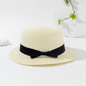 Detail of the high-quality woven straw boater hat with a chic black ribbon bow