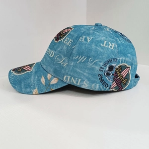 Detail of dark blue washed denim baseball cap with retro nautical patches and print