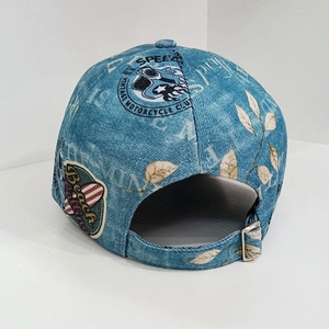 Detail of blue denim baseball cap with vintage embroidery and metal adjustable buckle