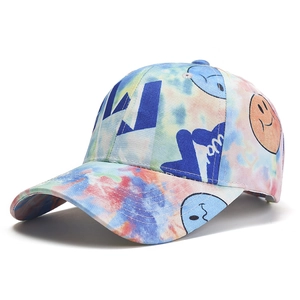 Tie-dye cotton baseball cap with smiley face and blue abstract pattern on white background